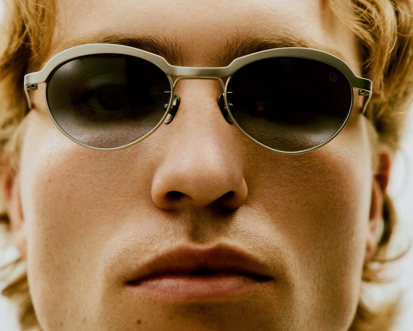 Theodor titanium frame styled on a clean surface with fashion accessories