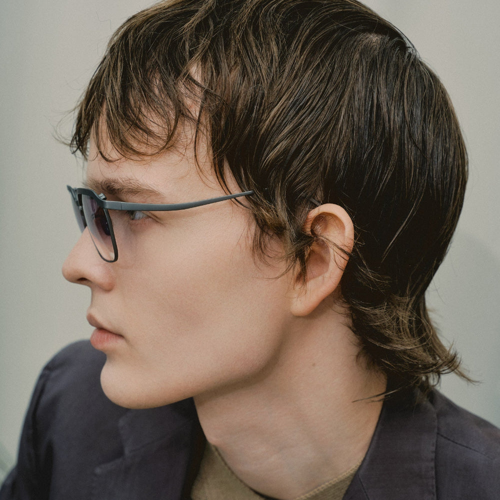 Side profile of a model wearing Vincent Catani Benno Space Grey Gradient titanium frames