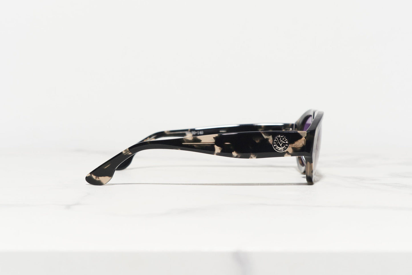 Profile of sunglasses made in Japan, designed by a Danish designer, showcasing the intricate frame details.