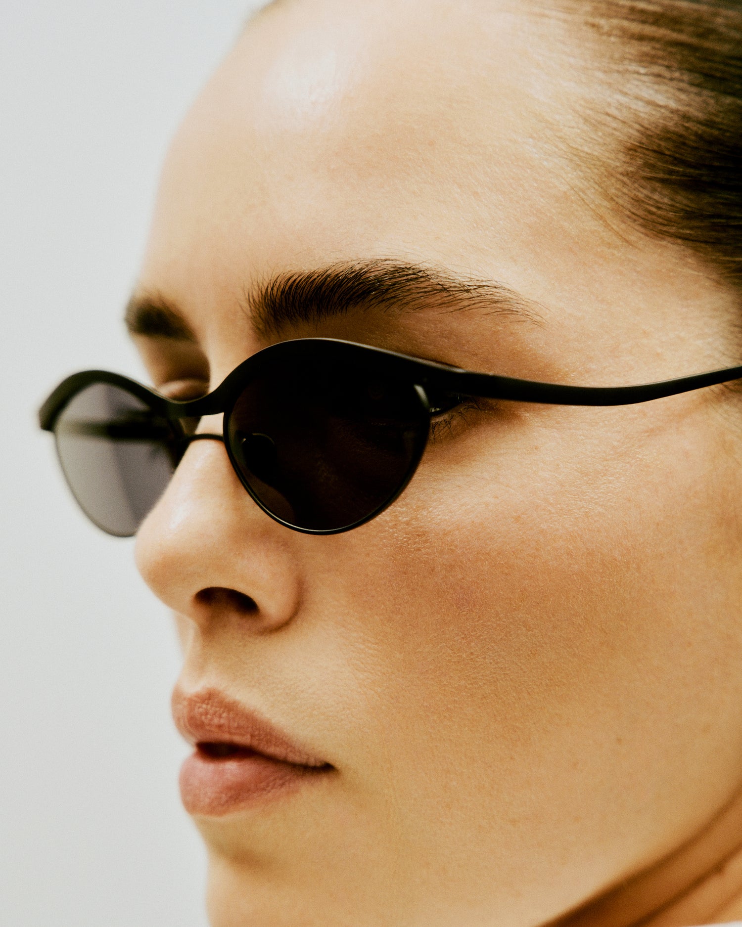 Model wearing Alma cat-eye glasses, designed in Denmark for bold elegance