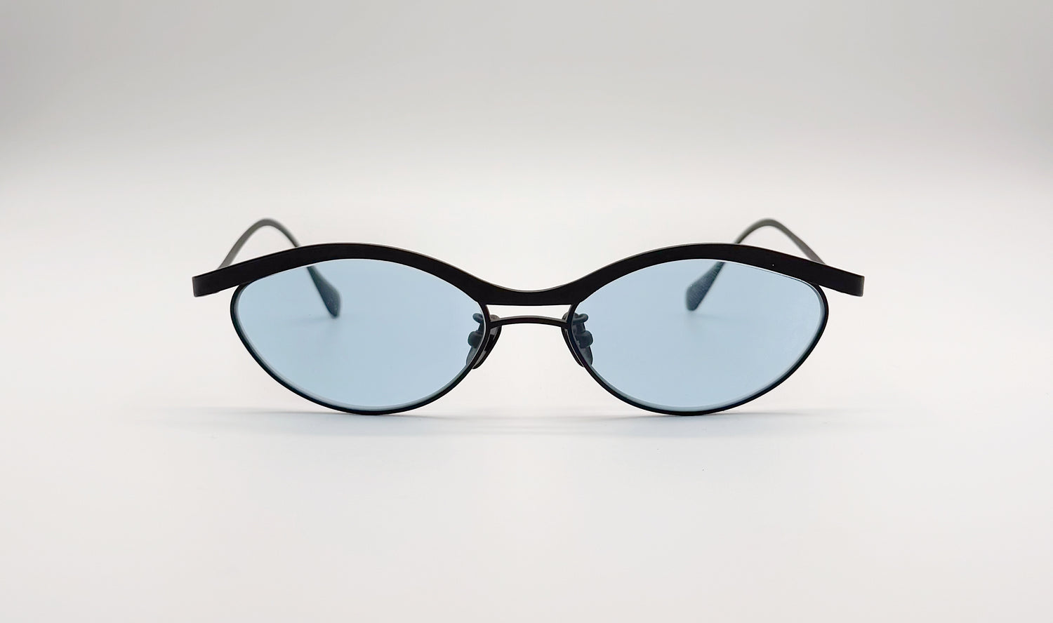 Front view of Vincent Catani Alma cat-eye sunglasses, thin black titanium frame with sky blue lenses