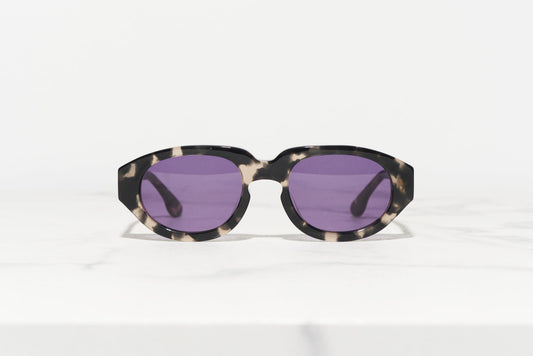 Stylish sunglasses made in Japan by a Danish designer, with a tortoiseshell frame and modern design.
